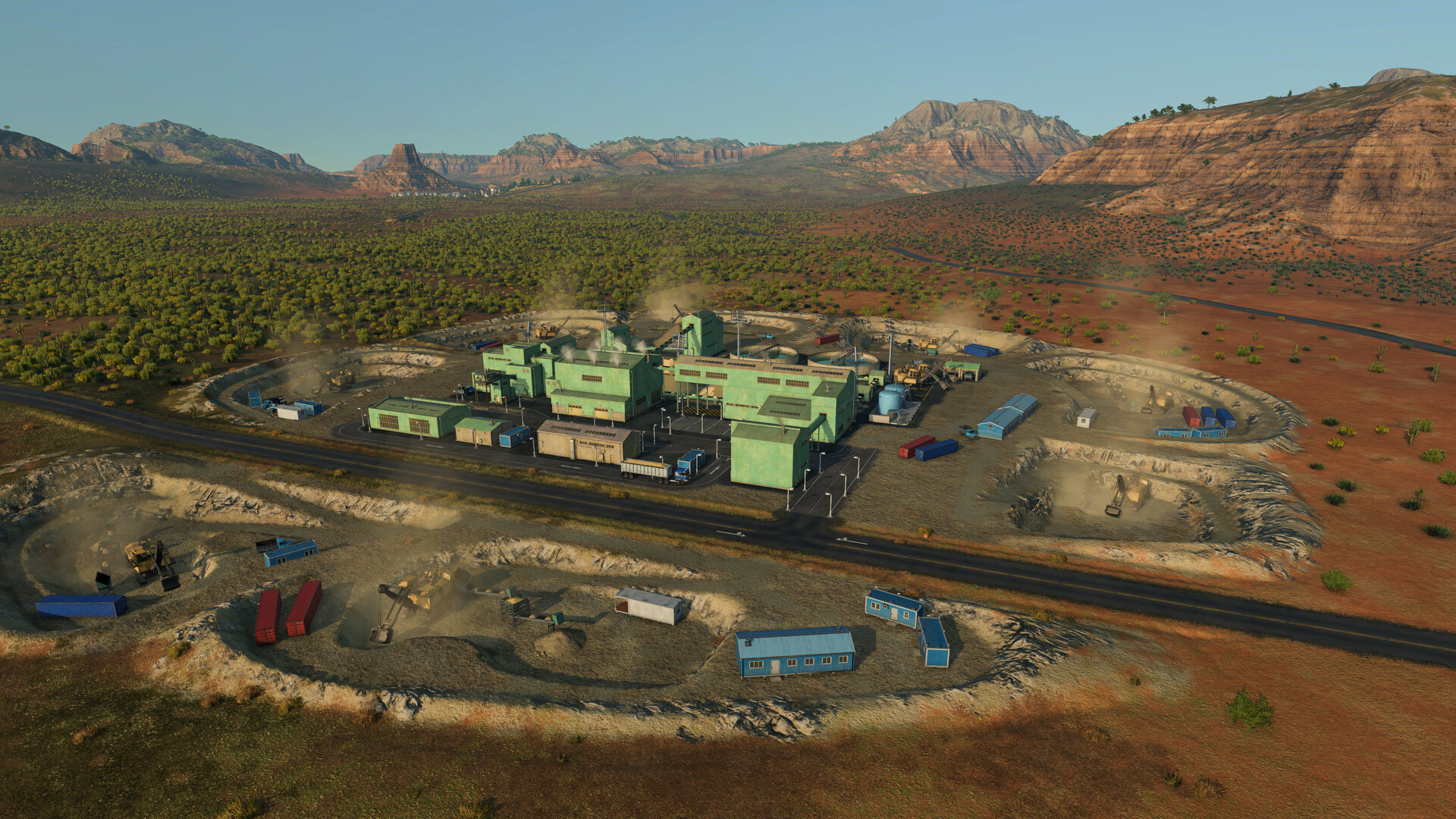 A large mining and processing complex in the desert with open pits, trucks, and factory buildings